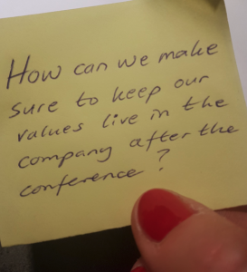 note on a post-it: how can we make sure to keep our values live in the company after the conference?